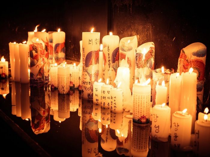 Chuseok candles lit in offering to those who have died. Photo by Jrwooley6