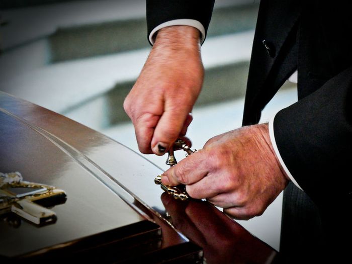 The CMA has proposed an investigation into the UK's funeral industry. Picture shows a funeral director closing a coffin
