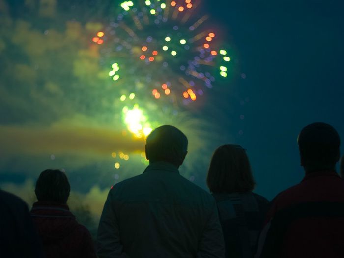 Family watching ashes being scattered in a firework display