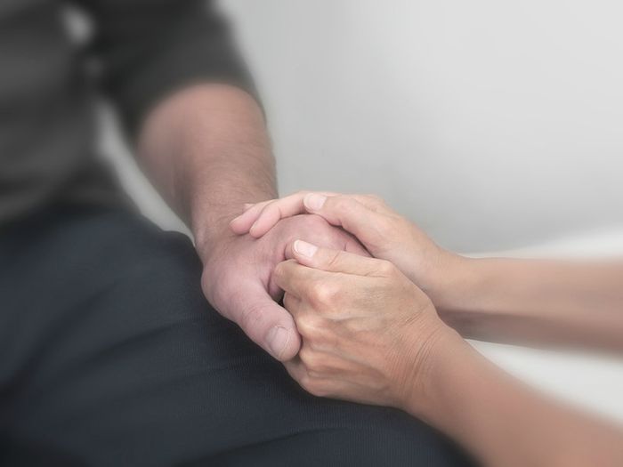 A bereavement officer comforts a grieving relative