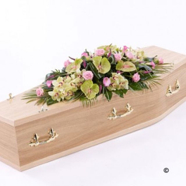 Traditional Coffin and striking floral tribute