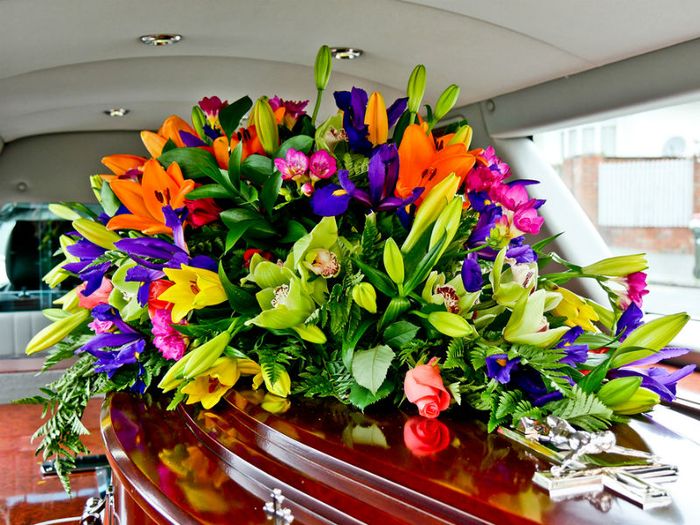 beautiful funeral flowers on coffin