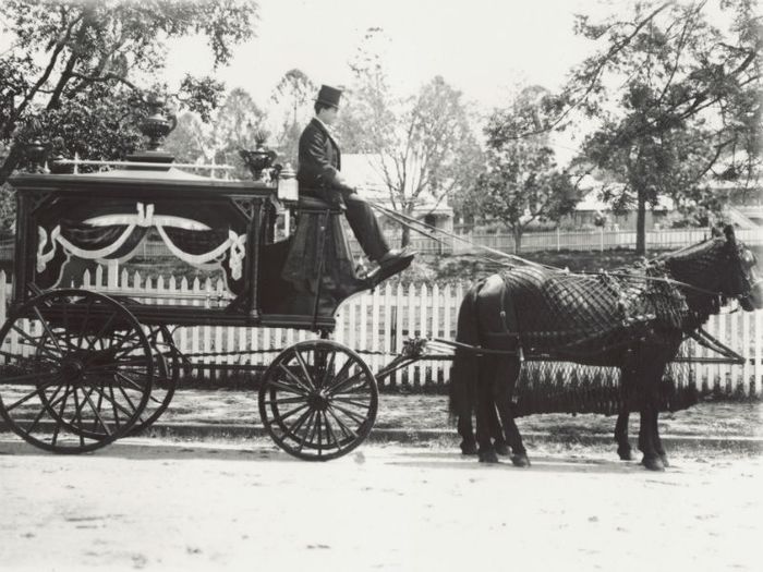 A traditional horse and carriage hearse