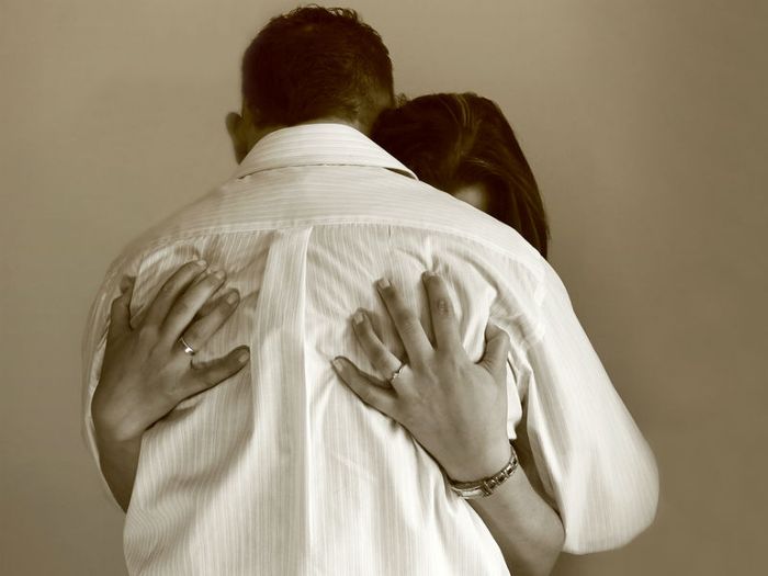 A grieving couple hug each other