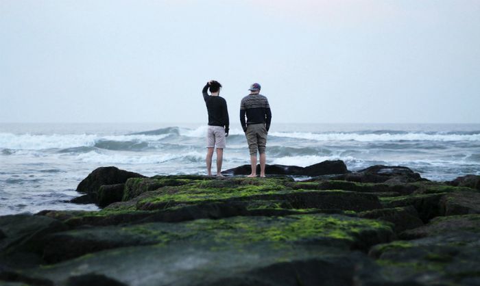Two people looking out to sea