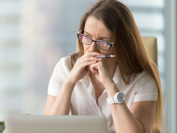 A sad and pensive woman at her computer