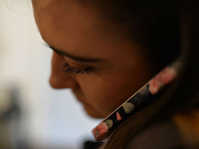 Volunteer listening on the phone to a grieving parent who needs support