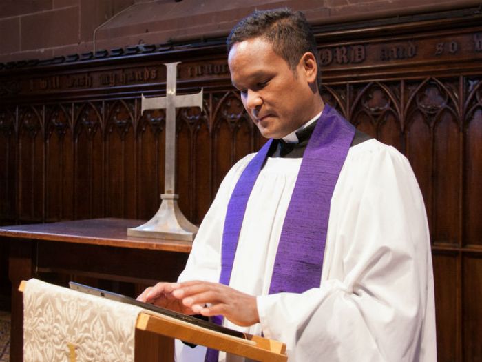 A Church of England minister leading a funeral